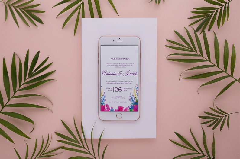 May include: A smartphone displaying a wedding invitation with a floral design. The invitation reads "Nuestra Boda" and features the names "Antonio & Isabel" and the date "Sabado 26". The phone is on a white background with green palm leaves.