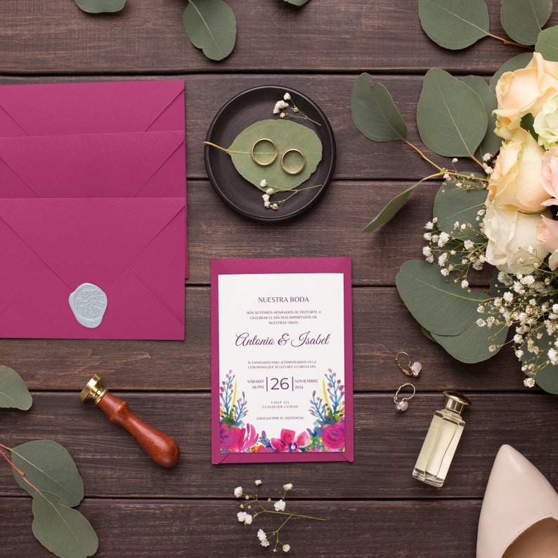 May include: A wedding invitation with a pink and white floral design. The invitation reads "Nuestra Boda" and includes the names "Antonio & Isabel" and the date "Sabado 26 de Noviembre de 2022".