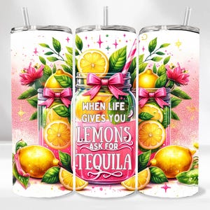 May include: A pink and white tumbler with a lemon and tequila design. The tumbler has the text "When life gives you lemons ask for tequila".