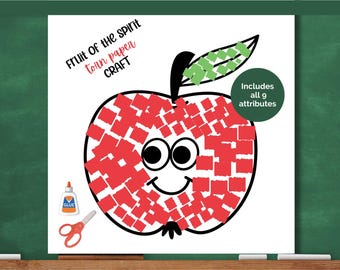 May include: A white paper craft with a red apple design, featuring a smiling face and a green leaf. The text "Fruit of the Spirit torn paper CRAFT" is at the top. Includes glue and scissors.