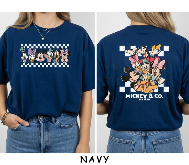 May include: A navy blue t-shirt featuring a front graphic of Disney characters in a white and navy checkered rectangle. The back displays a larger group of Disney characters over a checkered square with the text MICKEY & CO. EST 1928.