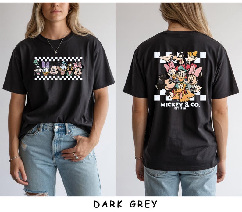 May include: A dark grey t-shirt featuring a front graphic of Disney characters in a black and white checkered box. The back displays a larger version of the same characters with the text MICKEY & CO. EST 1928 printed in white below the design.