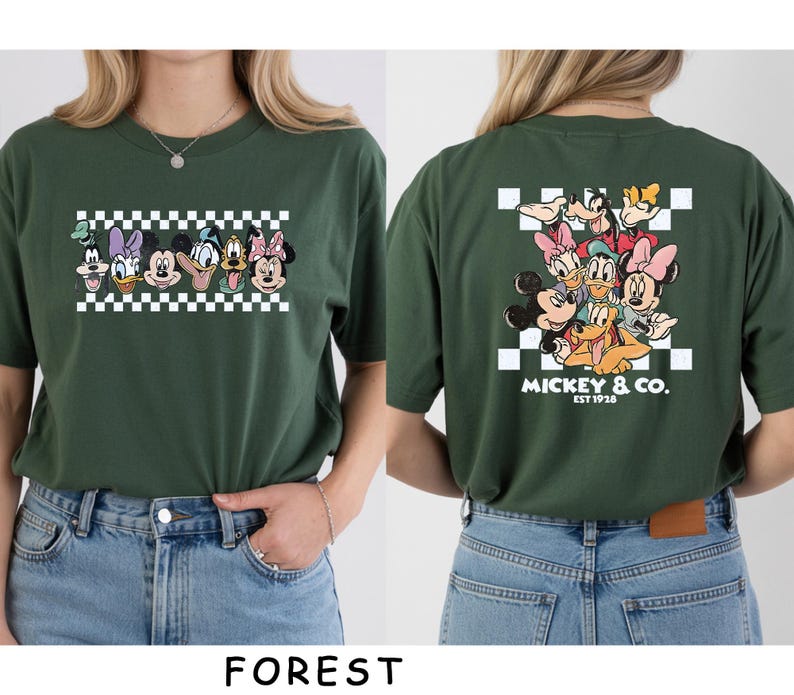 May include: A forest green t-shirt featuring a graphic of Disney characters on the front and back. The front shows a horizontal row of character faces over a checkerboard pattern. The back displays a larger group graphic with the text MICKEY & CO. EST 1928.