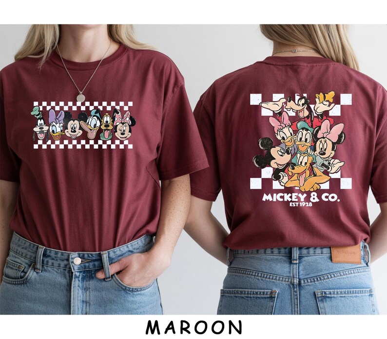 May include: A maroon t-shirt featuring a front graphic of Disney characters in a row over a white and maroon checkerboard pattern, and a back graphic of the same characters clustered over a checkerboard with the text MICKEY & CO. EST 1928.