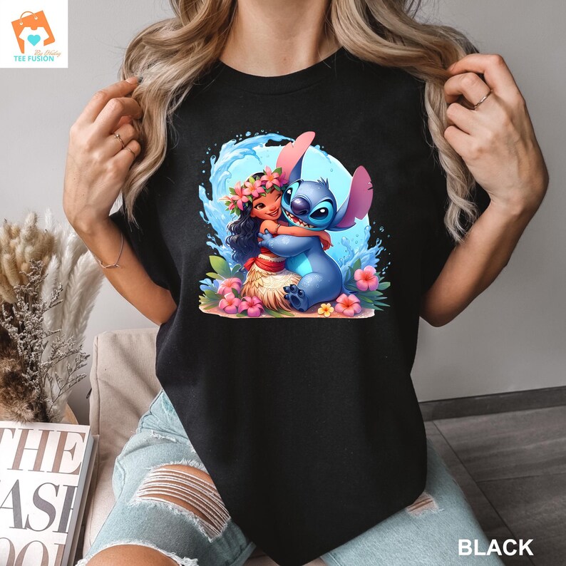 May include: Black t-shirt with a graphic of Stitch from Lilo & Stitch hugging Moana from Moana. The graphic is surrounded by blue water and pink flowers.