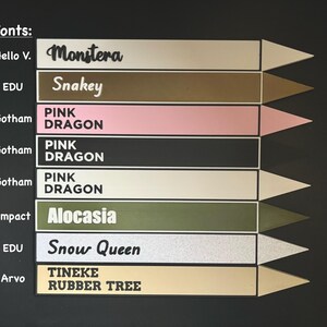 May include: A chart showing different fonts and their names. The fonts are displayed on a black background with a white border. The fonts are: Hello V., Monstera, Snakey, Gotham Pink Dragon, Impact Alocasia, EDU Snow Queen, Arvo Tineke Rubber Tree.