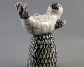 Seal performing on tall rock - ceramic raku fired pottery animal sculpture seaside beach figurine