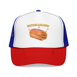 May include: A white, blue, and red trucker hat featuring a graphic of a loaf of bread with a cat face. The text "GLUTEN MORGEN" is printed in yellow above the bread graphic, accompanied by three small yellow star icons on a white front panel.