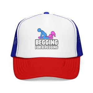 May include: A trucker hat with a white front panel, a red brim, and blue mesh back panels. The front features a graphic of a blue stick figure and a pink stick figure with the text BEGGING FOR A PEGGING printed in bold black capital letters below.