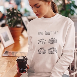 May include: White sweatshirt with the text "Yurt Sweet Yurt" and four black and white illustrations of yurts.