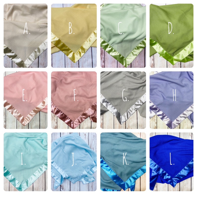 May include: Twelve different colors of baby blankets with satin trim. The blankets are arranged in a grid of four rows and three columns. Each blanket has a letter label in the center. The letters are A, B, C, D, E, F, G, H, I, J, K, and L.