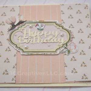 4 x 5.5 inch card in Peach floral and striped printed paper. Happy Birthday cutout in center  decorated with fussy cut flowers and white pearls .