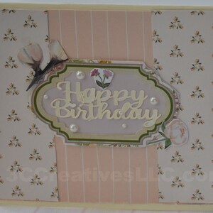 4 x 5.5 inch card in Peach floral and striped printed paper. Happy Birthday cutout in center  decorated with fussy cut flowers and white pearls .