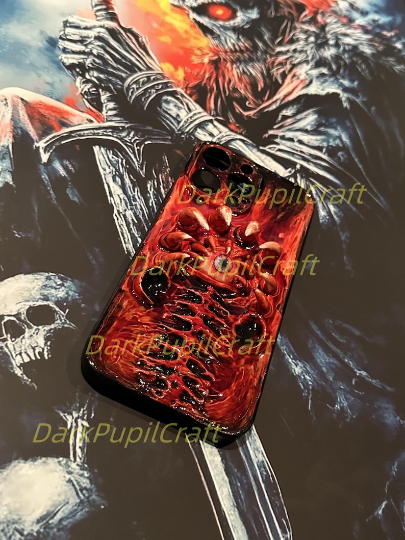 May include: A red and black phone case with a detailed image of a skull and bones. The case has the text "DarkPupilCraft" printed on it.