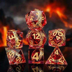 May include: Set of seven polyhedral dice in transparent red resin with gold-colored numbers and decorative accents. The dice include a D4, D6, D8, D10, D12, D20, and a percentile die. Ideal for tabletop role-playing games.