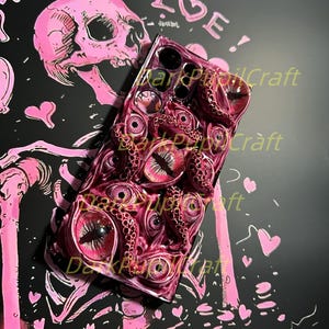 May include: A black phone case with a 3D design of pink and red tentacles and eyes. The case has the text "Dark Popcraft" printed on it.