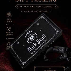 May include: A black rectangular gift box featuring white printed graphics of an eye, moon phases, and stars. The text reads Dark Pupil Gothic Decoden Phone Case. A black ribbon with the text Dark Pupil is included alongside the box.