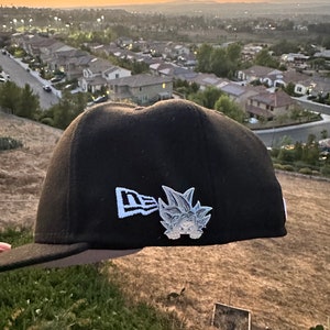 May include: A set of three ceramic mugs with a speckled, cream-colored glaze. Each mug features a different hand-painted design: a blue and green leaf, a yellow flower, and a red berry. The mugs have a simple, modern design.