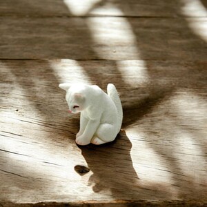 🐾 10 SEO Picture Blurbs (≤ 500 characters each)

Tiny cat figurine – the perfect addition to your fairy garden or desk décor.

Collectible kitty statue for cat lovers and miniature décor enthusiasts.

Handcrafted detail brings charm and personality to your display.

Small size makes it ideal for terrariums, dollhouses, or tiny scenes.

Unique gift for birthdays, stocking stuffers, or cat-themed presents.