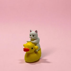 Looking for a small but unforgettable gift? This tiny cat riding duck figurine packs personality into every inch. Handmade for maximum cuteness, it makes an excellent gag gift, stocking stuffer, or unique décor piece. Perfect for cat lovers, office coworkers, or anyone who appreciates miniatures that add humor and charm to their day.