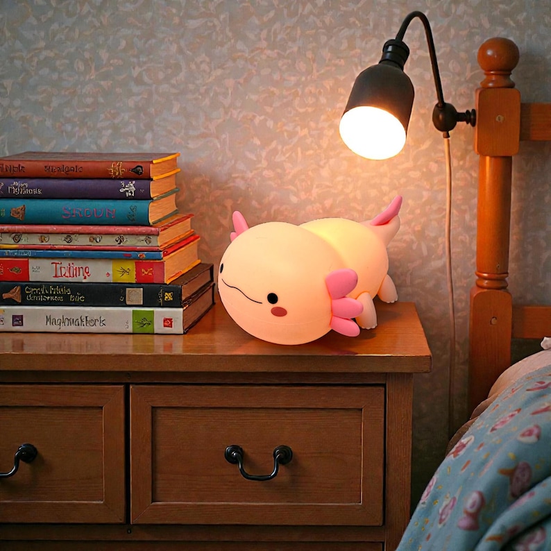 This adorable axolotl night light brings a calming glow and playful personality to kids’ bedrooms. Featuring three light modes and a timer, it’s easy to customize for any nighttime need. The squishy silicone design makes it fun to handle while remaining safe for children. A perfect pink animal lamp for bedtime routines, nurseries, and cozy nighttime comfort.