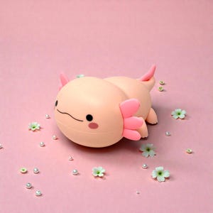 This pink axolotl night light is the perfect blend of cute, calming, and practical. Made from soft, kid-friendly silicone, it features three adjustable light modes and a convenient timer for nighttime use. Whether used as a nursery lamp, bedtime light, or decorative accent, this squishy axolotl helps kids feel safe, relaxed, and ready for sleep.