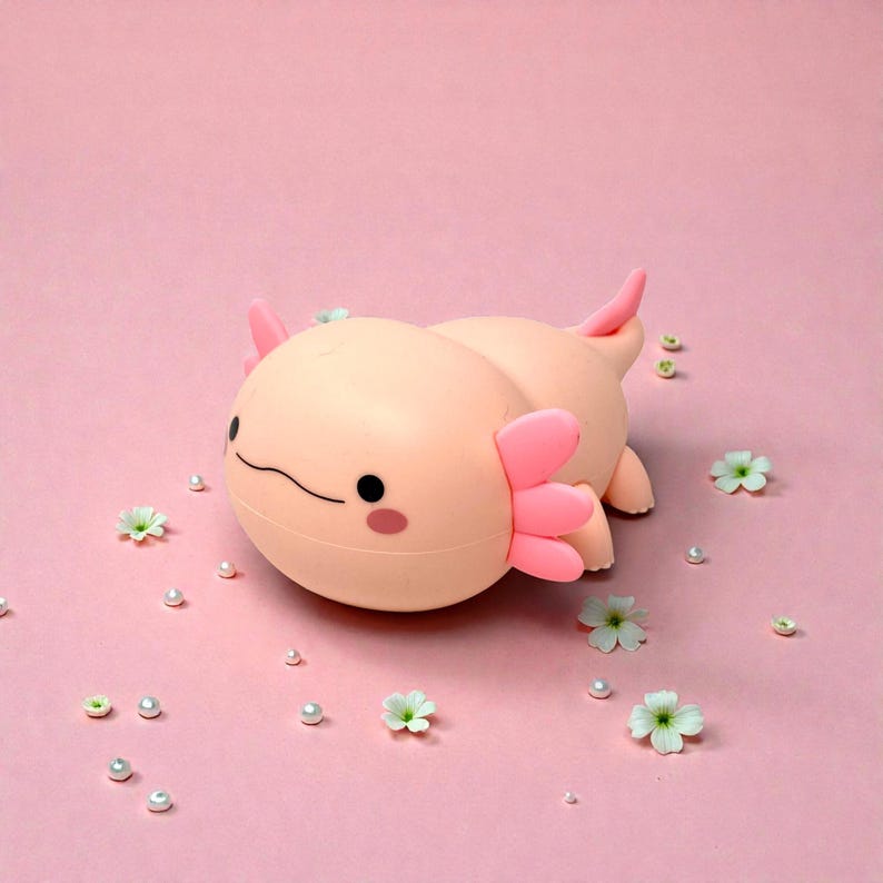 This pink axolotl night light is the perfect blend of cute, calming, and practical. Made from soft, kid-friendly silicone, it features three adjustable light modes and a convenient timer for nighttime use. Whether used as a nursery lamp, bedtime light, or decorative accent, this squishy axolotl helps kids feel safe, relaxed, and ready for sleep.