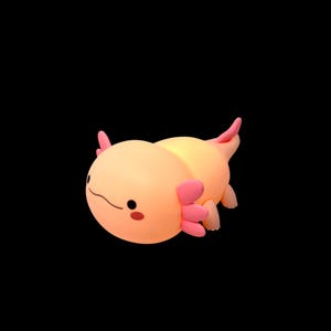 Sweet, soothing, and irresistibly cute, this squishy axolotl night light is a bedtime favorite for kids. The warm LED glow creates a calming atmosphere, while three brightness options and a timer make it easy to use every night. With its pink axolotl design and soft silicone feel, it’s both a comforting night light and playful room accent.