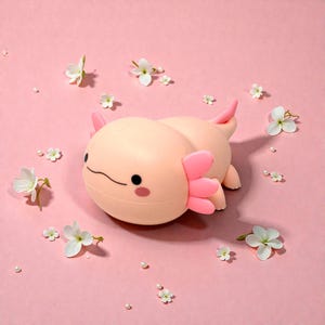 Add a touch of magic to bedtime with this adorable squishy axolotl night lamp. Its gentle LED light is easy on young eyes, making it ideal for nurseries and kids’ bedrooms. Choose from three light settings to create the perfect mood, then set the timer and relax. This pink axolotl night light is both functional lighting and cute animal decor.