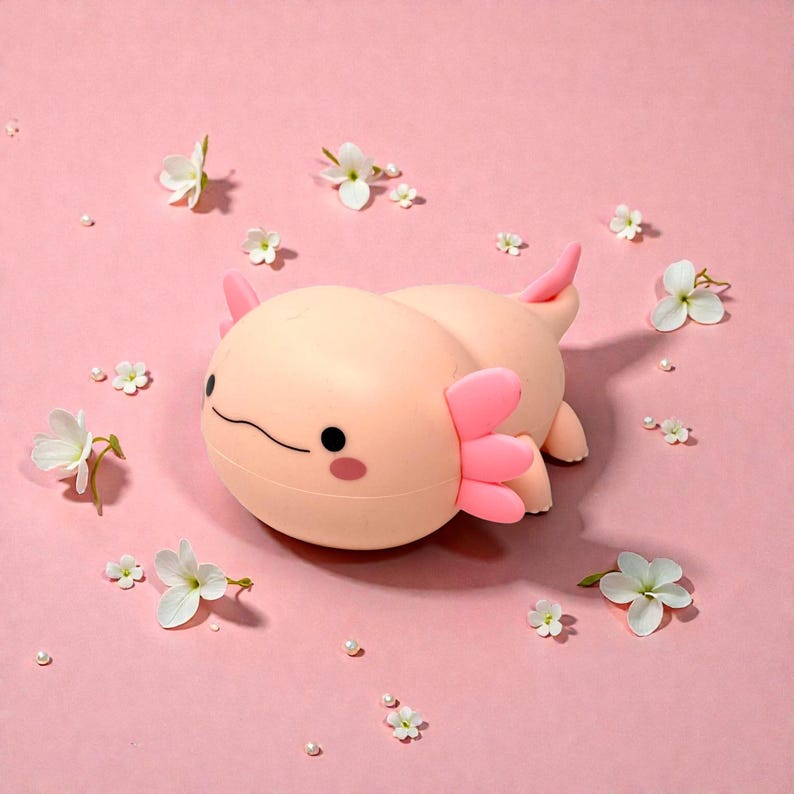 Add a touch of magic to bedtime with this adorable squishy axolotl night lamp. Its gentle LED light is easy on young eyes, making it ideal for nurseries and kids’ bedrooms. Choose from three light settings to create the perfect mood, then set the timer and relax. This pink axolotl night light is both functional lighting and cute animal decor.