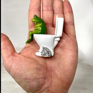 This silly frog toilet figurine is designed for maximum laughs. Whether used as bathroom decor, desk decor, or shelf styling, it’s a unique novelty frog statue that stands out. Makes a perfect gag gift, funny gift, or whimsical home accent for frog lovers of all ages.