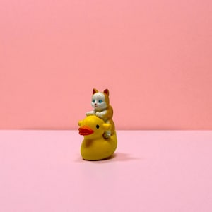 This miniature cat riding duck figurine is a guaranteed crowd-pleaser. Whether you’re shopping for stocking stuffers, funny gifts, or quirky décor, this piece delivers charm and laughter. Cat lovers and collectors enjoy its hand-crafted details, while gift-givers love its easy, humorous appeal. A tiny treasure perfect for holidays and everyday smiles.