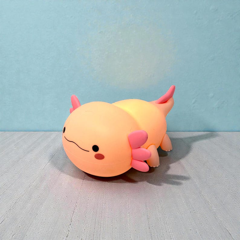 This squishy axolotl night light is designed to make bedtime easier and more enjoyable for kids. The gentle LED glow, three adjustable brightness levels, and built-in timer provide comfort without harsh light. Its pink axolotl shape adds a fun, whimsical touch to nurseries and children’s rooms, making it a thoughtful gift for birthdays or baby showers.