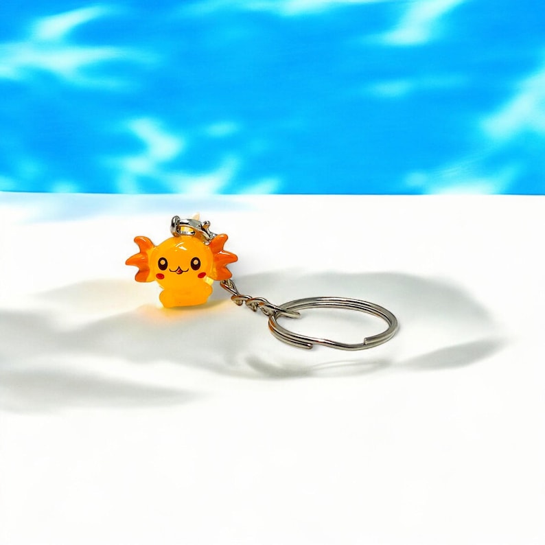 Our Mini Axolotl Keychain is the perfect balance of cute and collectible. Designed to bring joy, it’s great for attaching to keys, lanyards, or backpacks. This tiny creature’s adorable face makes it irresistible—perfect as a small gift for birthdays, holidays, or just to brighten someone’s day!