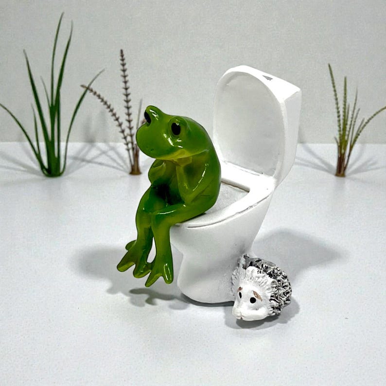 Bring humor to your home with this funny frog toilet figurine. Designed for laughs, this silly frog decor is perfect for bathrooms, guest spaces, offices, and dorm rooms. A popular novelty gift and stocking stuffer, it’s a unique frog statue that frog lovers and humor fans can’t resist.