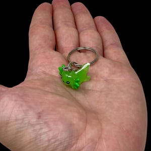 Tiny but full of personality, this Mini Axolotl Keychain makes a great keepsake for animal lovers. The adorable amphibian design fits perfectly with any aesthetic—from kawaii and cottagecore to cozy and handmade. A small gift that leaves a big impression on anyone lucky enough to receive it!