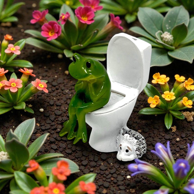 This silly frog on toilet figurine combines cute design with hilarious bathroom humor. A standout piece of novelty frog decor, it’s ideal for gifting, collecting, or displaying. Perfect for frog lovers, funny gift seekers, and anyone who enjoys whimsical home accents.
