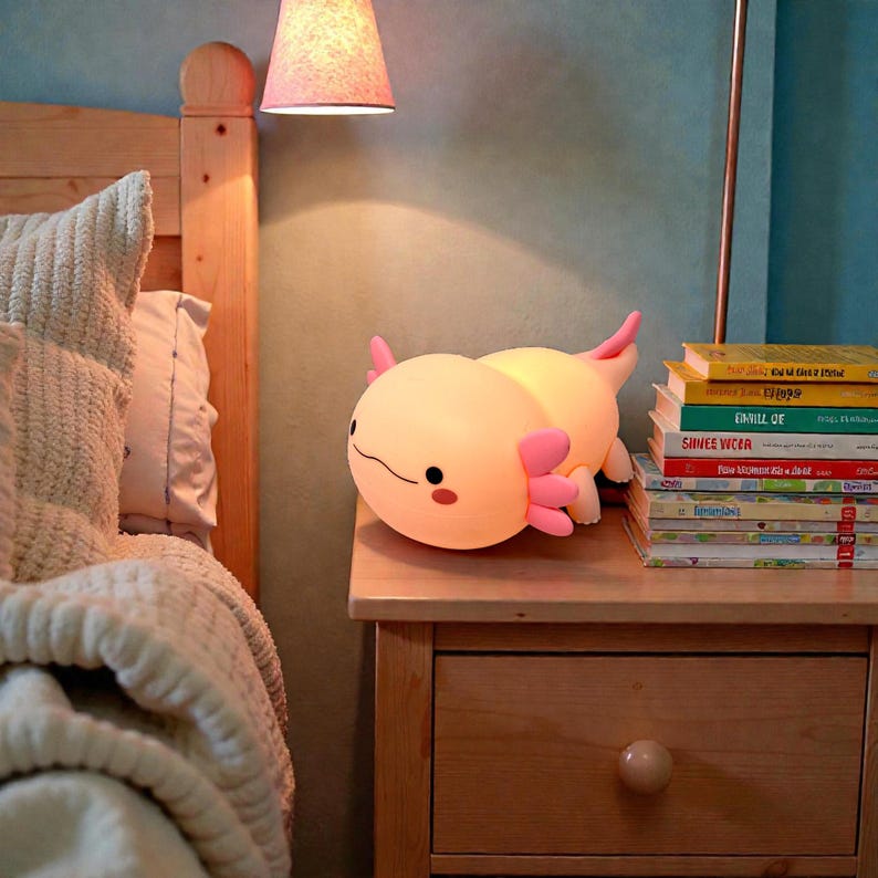 Cute meets comfort with this pink squishy axolotl night light, designed to help kids feel secure at night. The soft silicone body is safe to touch, and the gentle LED lighting offers three adjustable settings for the perfect glow. With a timer feature for hands-free use, this axolotl lamp is ideal for nurseries, kids’ rooms, and bedtime gifting.