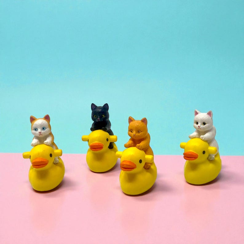 Celebrate the weird and wonderful with this silly cat-on-duck figurine. Handmade with love, it’s the perfect gag gift or stocking stuffer for anyone who enjoys quirky collectibles. Its small size makes it ideal for desks, shelves, and gift bags, while its adorable design ensures it becomes an instant favorite for cat lovers and décor fans.