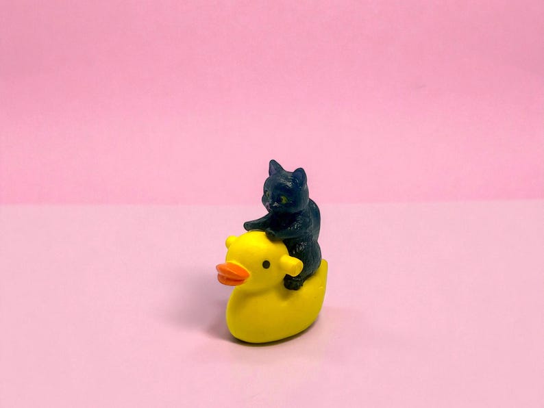 Give a gift that guarantees laughs with this mini cat riding duck figurine. Its charming, handcrafted details make it a standout stocking stuffer, white elephant gift, or funny desk accessory. Perfect for quirky décor lovers, cat parents, and miniature collectors, it adds personality and humor to any space while showing off your unique gift-giving style.