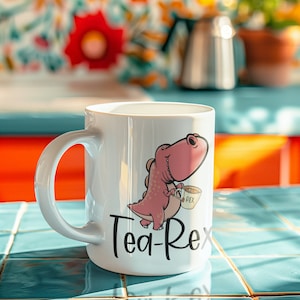 May include: White ceramic mug with a pink dinosaur cartoon holding a teacup and the text "Tea-Rex".