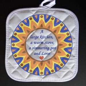 May include: White quilted pot holder with a colorful circular design featuring a sunflower and the text "A large kitchen, a warm stove, a simmering pot and Love" with a red heart.