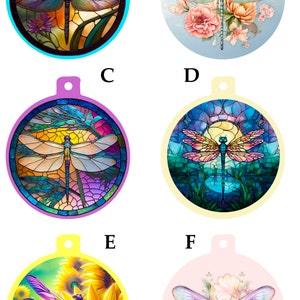 May include: Six round ornaments with a dragonfly design. The ornaments are in different colors and feature different backgrounds, including stained glass, flowers, and sunflowers.