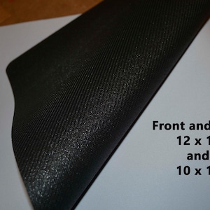 May include: A black mouse pad with a textured surface. The mouse pad is folded in half, revealing a white surface with the text "Front and back 12 x 18 and 10 x 16".