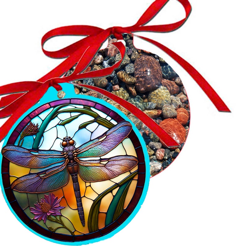 May include: A round, blue and turquoise Christmas ornament with a stained glass dragonfly design. The dragonfly has iridescent wings and a brown body. The ornament is tied with a red ribbon.