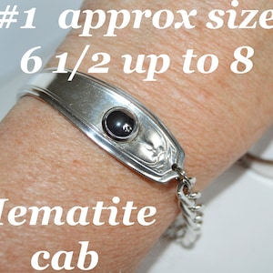 May include: Silver bracelet with a black hematite cabochon, #1 approx size 6 1/2 up to 8. Hematite cab.
