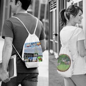 May include: Two white drawstring backpacks with different designs. One backpack features a colorful image of the Mackinac Bridge and the word "Michigan". The other backpack features a nature scene with birds.