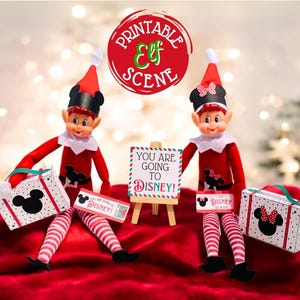 May include: Two elf dolls dressed in red and white striped outfits with black Mickey Mouse ears and a red bow. The elves are holding suitcases and a sign that says "You are going to Disney!"
