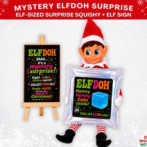May include: A toy elf doll holding a silver foil mystery squishy package labeled ELFDOH with a blue cube graphic. Beside it, a black sign on a wooden easel reads ELFDOH Shhh... It's a mystery surprise! Eight colors, Endless squish! COLLECT THEM ALL!