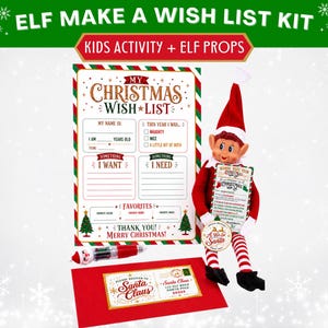 May include: An Elf Make A Wish List Kit featuring a Christmas wish list form, a red envelope addressed to Santa Claus, and a red and white striped elf doll holding a small sign. The kit includes a red and white pen with a Santa Claus topper.